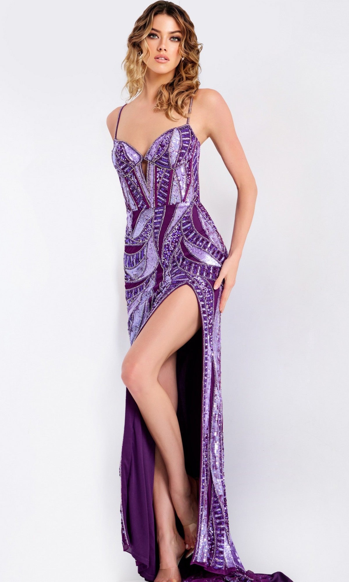 A woman poses in the Jovani 49228 long prom dress, featuring geometric sequins, spaghetti straps, a fitted floor-length silhouette, and a thigh-high slit against a plain background.
